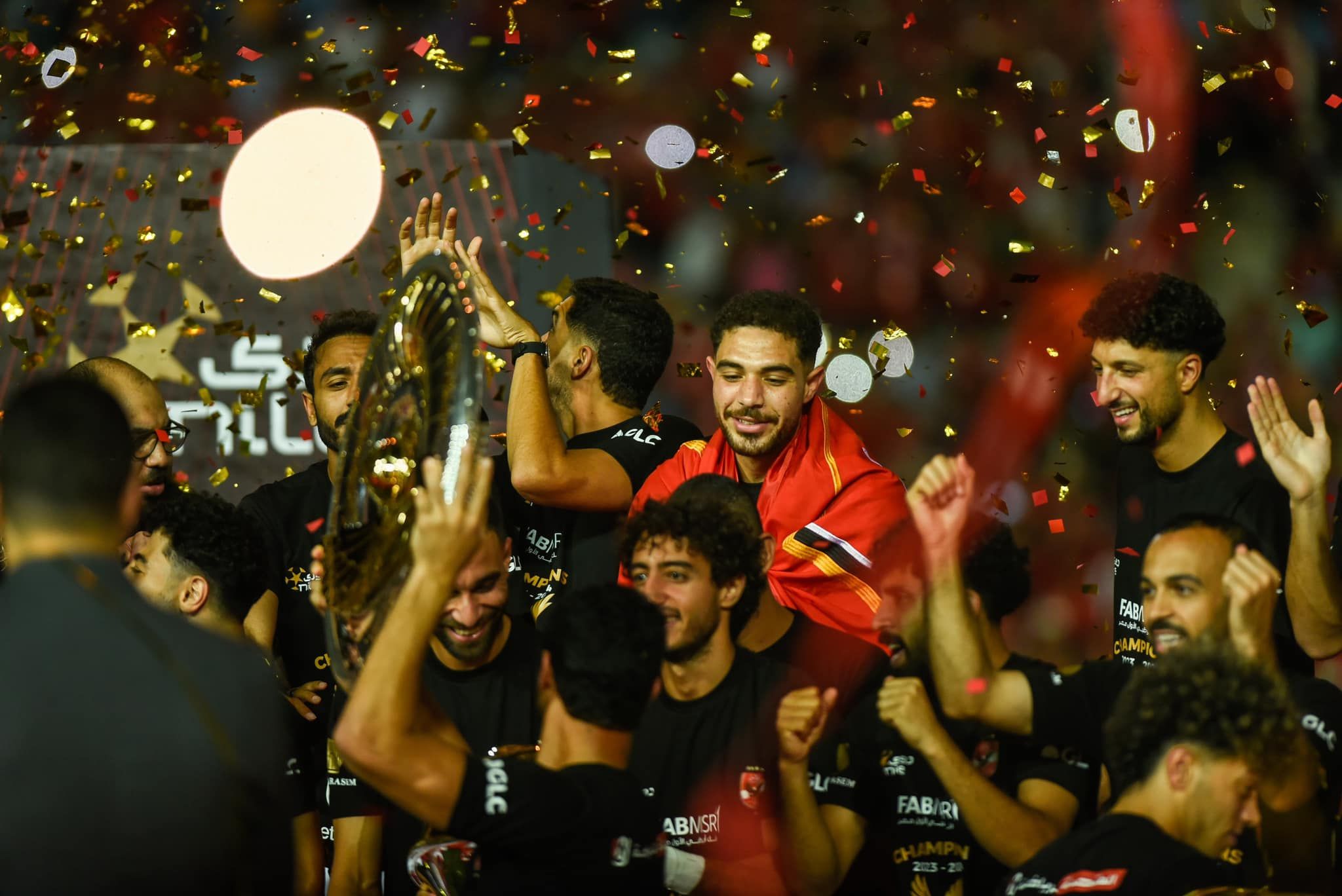 May be an image of 5 people, people playing soccer, crowd and text